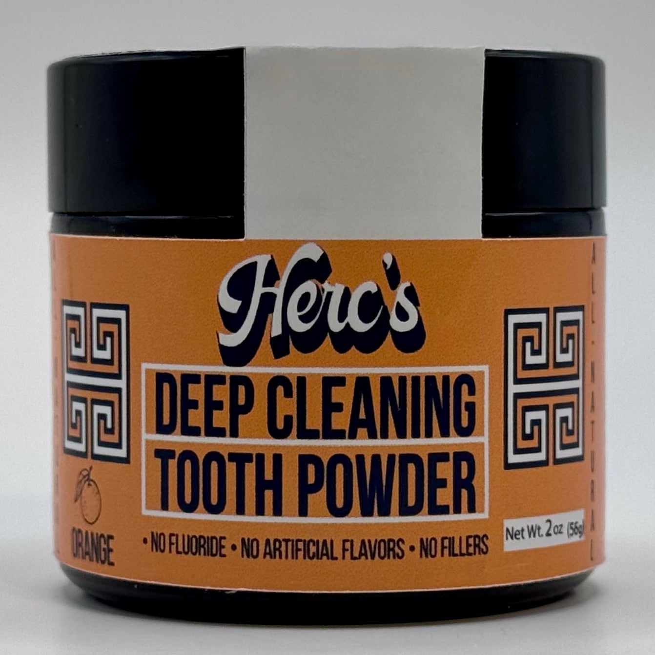 Jar of Herc's Deep Cleaning Tooth Powder with a black lid on a gray background