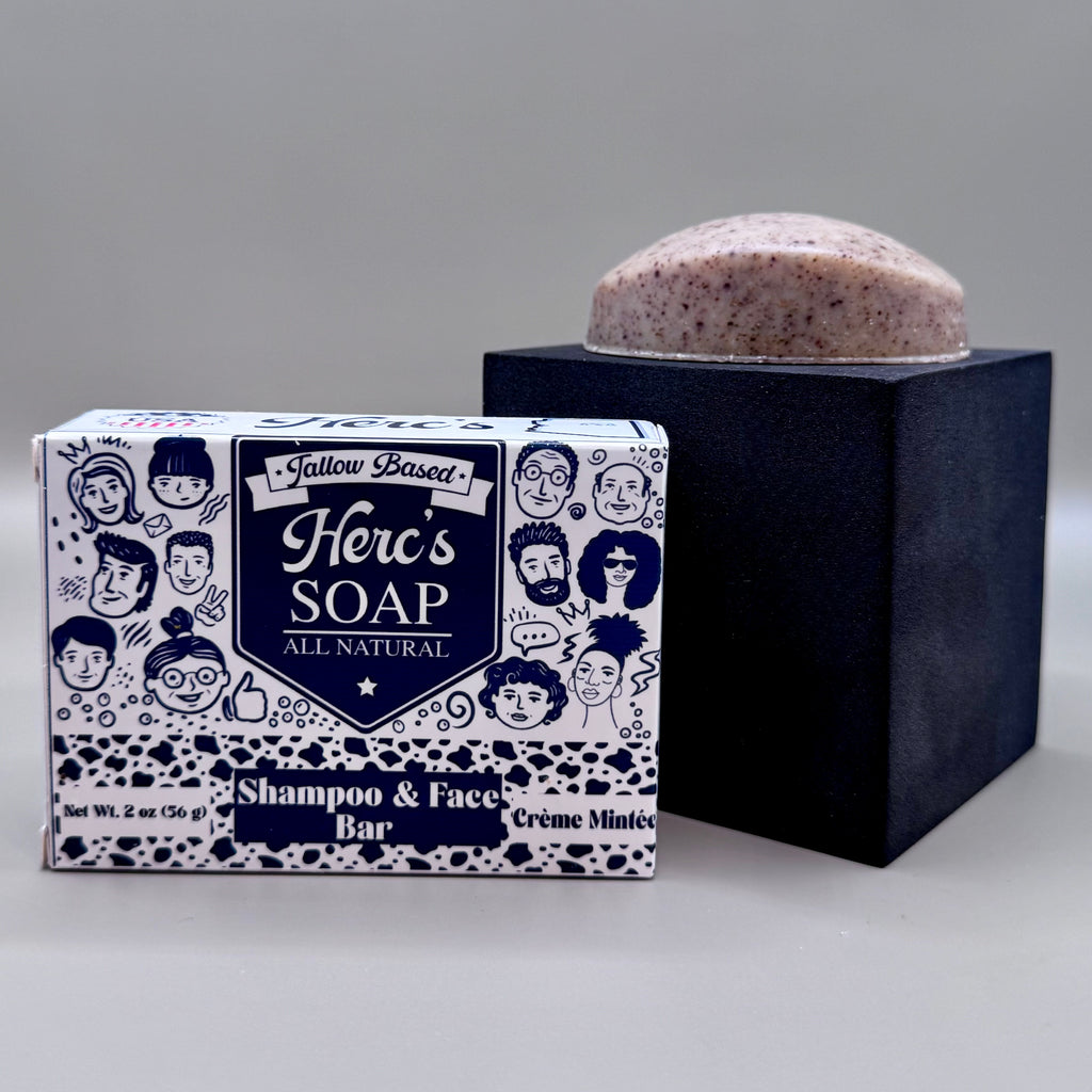 Herb's Soap shampoo and face bar with packaging on a gray background