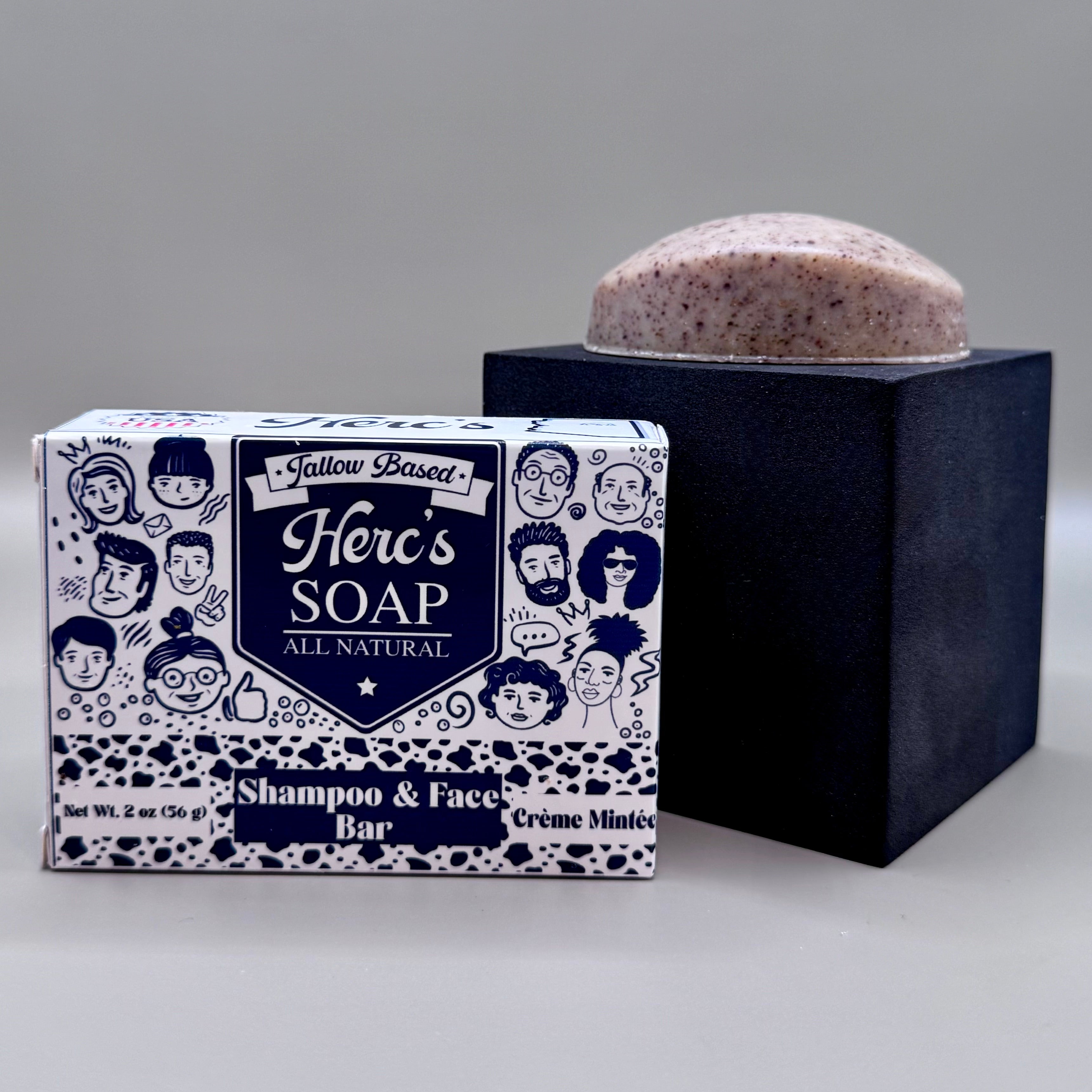 Herb's Soap shampoo and face bar with packaging on a gray background