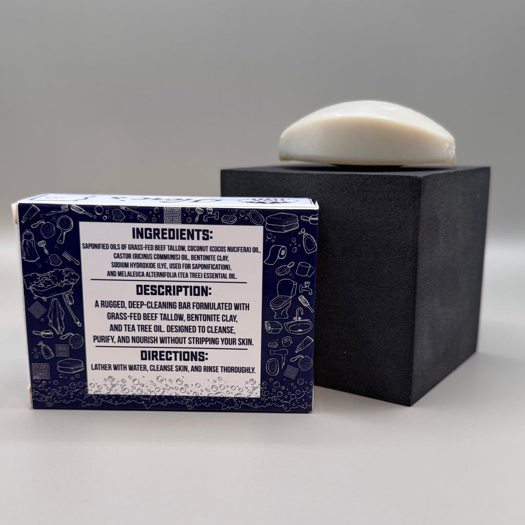 Bar of soap with a black box featuring ingredient details on a gray background